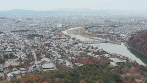 kyoto aerial establishing shot with arashiyama and togetsu bridge in background