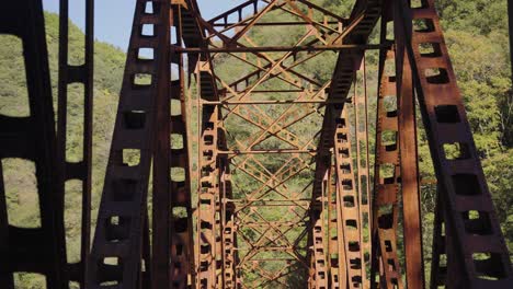 old iron bridge of takedao abandoned railway hike, tilt reveal of structure
