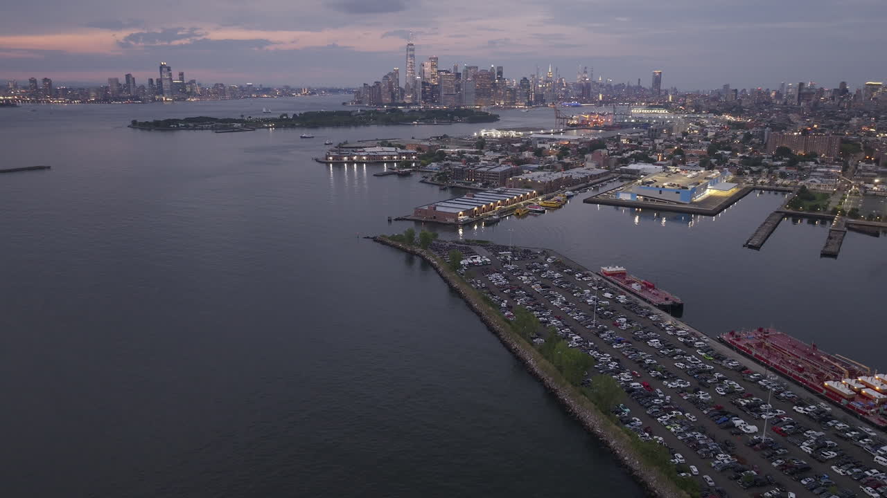 Aerial view of Brooklyn and the Manhattan skyline at night. Shot in Red Hook along the New York Harbor and Governor's Island.