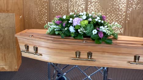 closeup shot of a funeral casket or coffin in a hearse or chapel or burial at cemetery