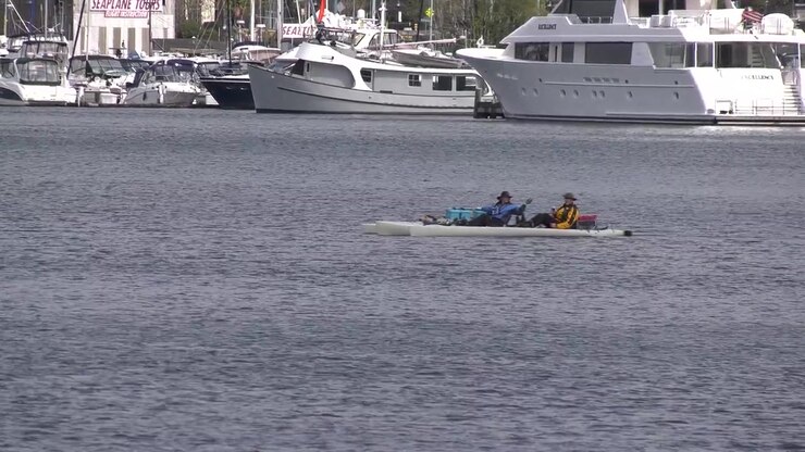 kayakers move down stream in river