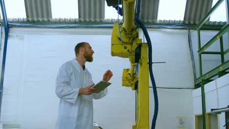 robotic engineer examine robotic machine in warehouse 4k