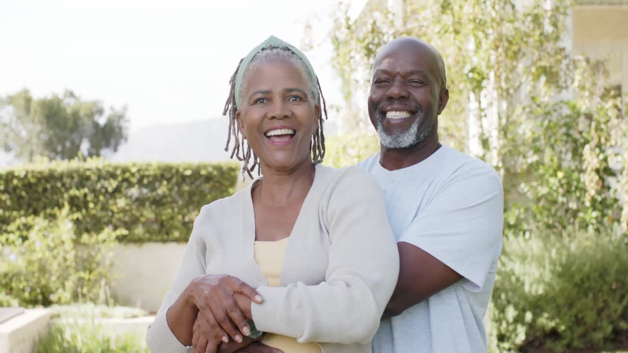 Portrait of happy african american senior couple embracing in sunny ...