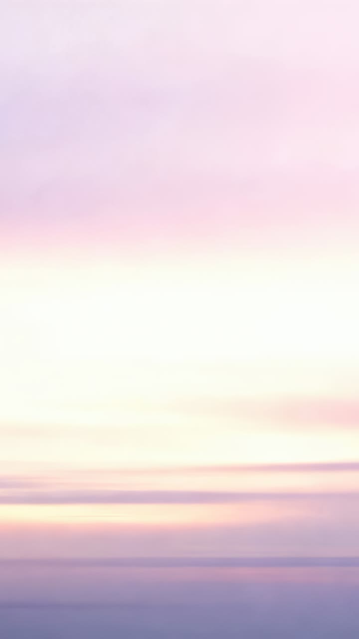 Vertical video: Shifting pastel sky showing sunrise light brightening over horizon, thin clouds