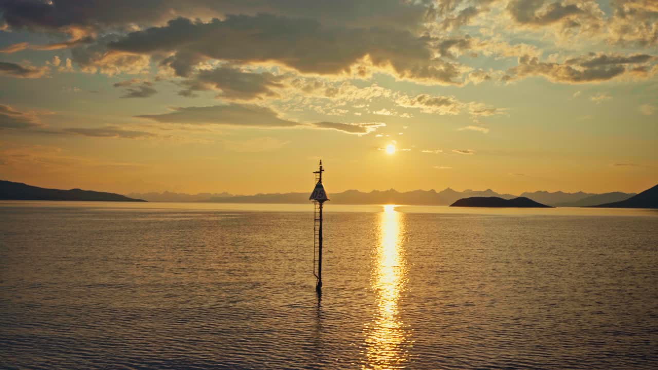 A Serene Sunset Reflects Over Calm Waters as a Navigation Marker Stands Near Bognes Ferry - Wide Shot
