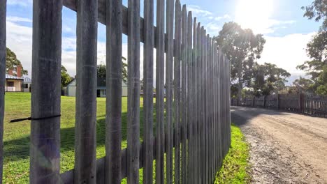 pathway beside a wooden fence in sunlight