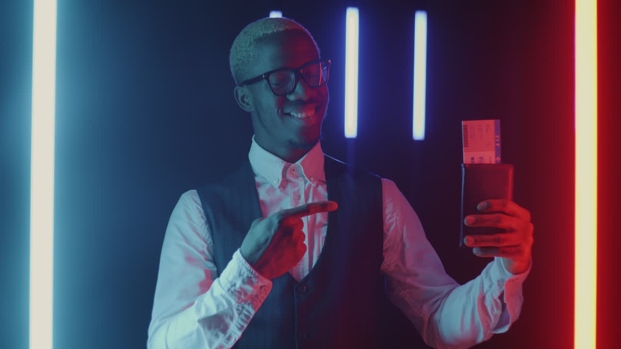 Man Displaying Tickets in Neon Lights