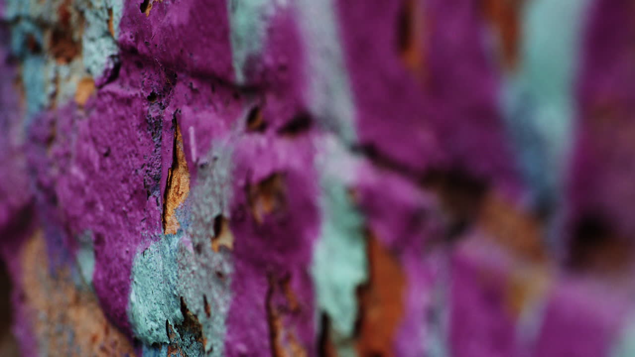 Purple and blue green chipped paint background, focus pull
