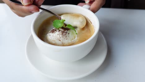 persona disfrutando de una bebida de café con helado y menta