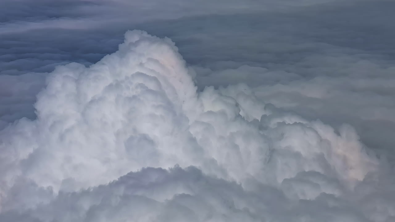 Dense cumulonimbus formations seen from an aircraft window