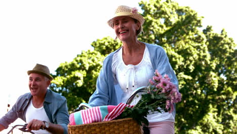 Senior-couple-going-on-a-bike-ride-in-the-city