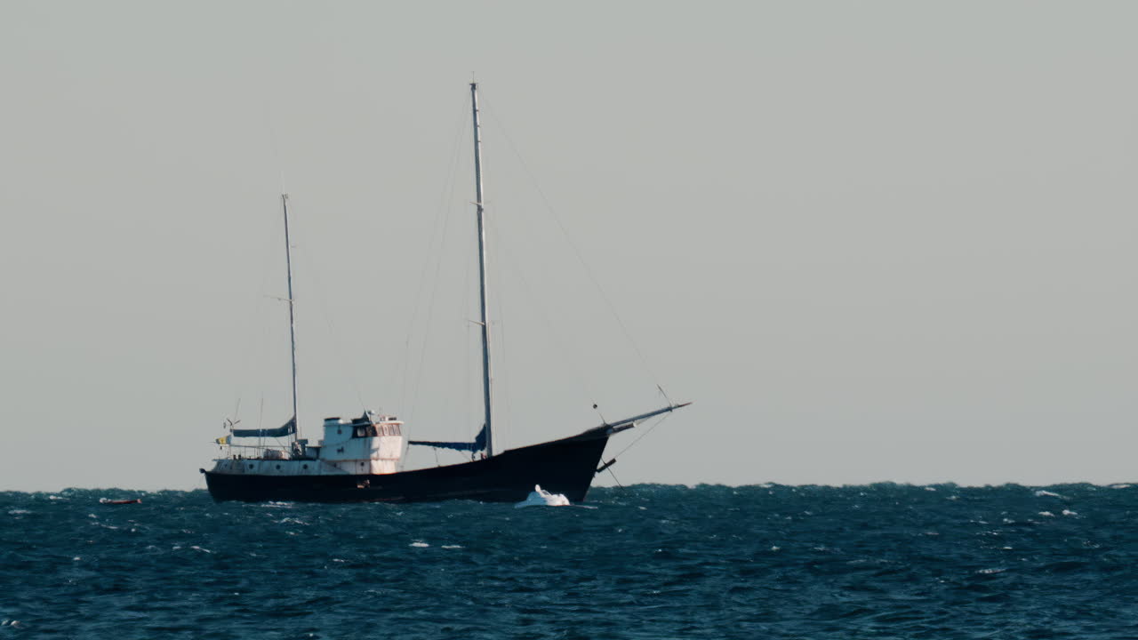Distant view of a boat moving on the sea in the evening