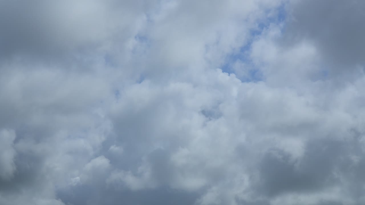 Cumulonimbus clouds forming close up on bight summer day