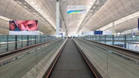 moving through airport on a travelator