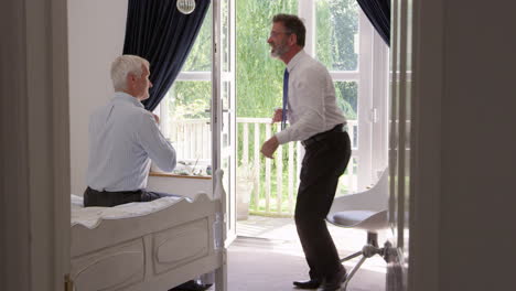 Homosexual-Couple-In-Bedroom-Getting-Dressed-For-Work