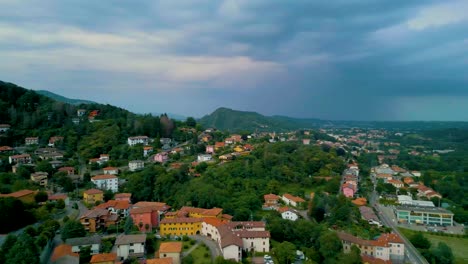 4k aerial drone video of mountainside farmhouses and vineyards in cavallasca, italy on a summer evening