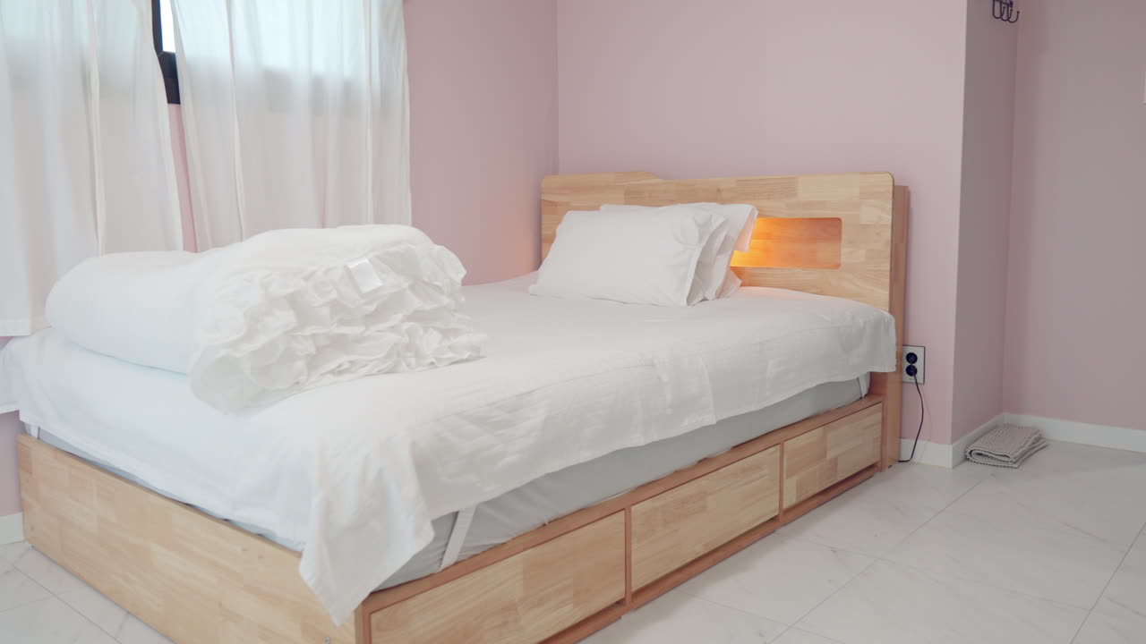 Slow Pan Right on Kid's Room Made-up White Wooden Bed For One Person With Pillows in Villa Resort, Pink Walls, Ceramic Tiled Floor