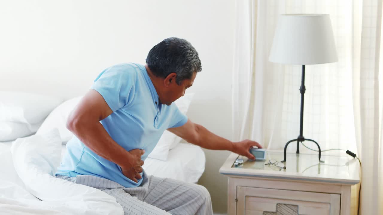 Upset senior man suffering from stomachache 4k