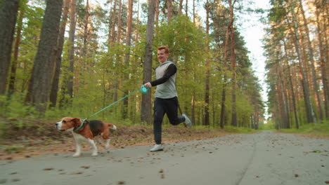 man running with dog in forest