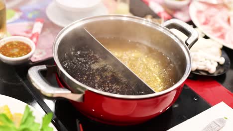 simmering hotpot with ingredients and sauces