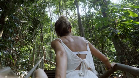 couple holding hands woman leading the way to tropical rainforest in cost rica exploring lush green jungle and wildlife - slow motion. people travel follow me concept