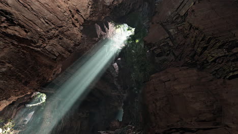 sunbeams shining through a cave opening