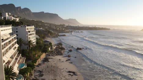 ocean waves - people playing volleyball at clifton beach in cape town, south africa
