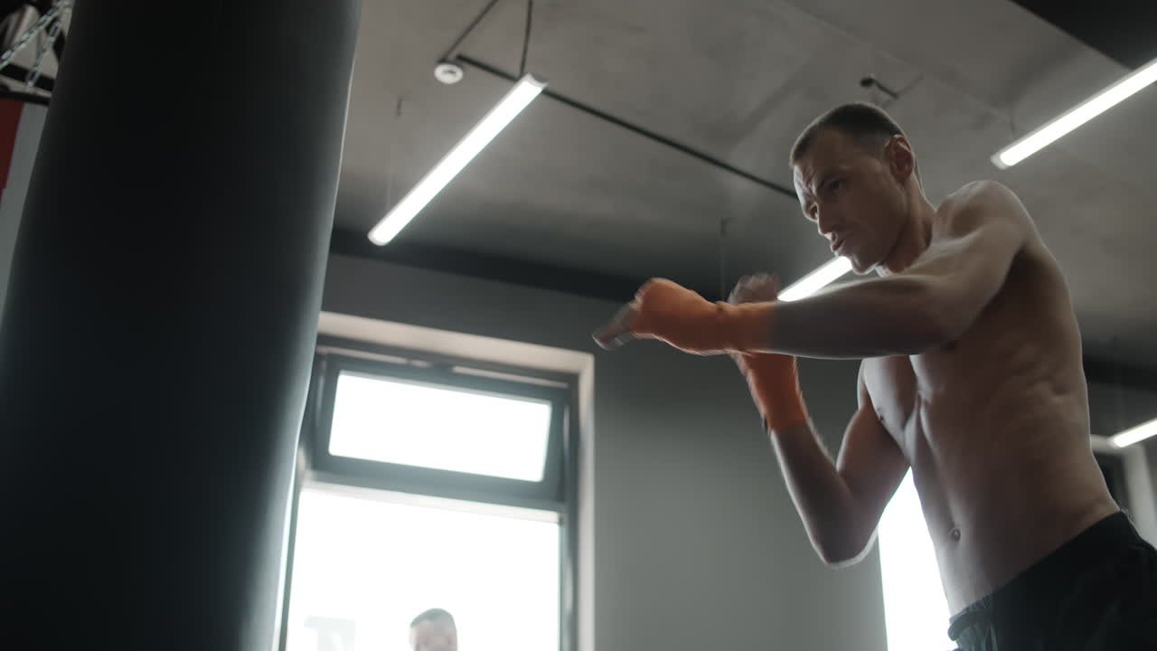 Man practicing Muay Thai in a gym