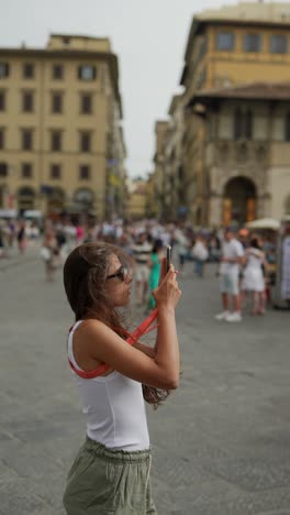 woman taking pictures in florence, italy