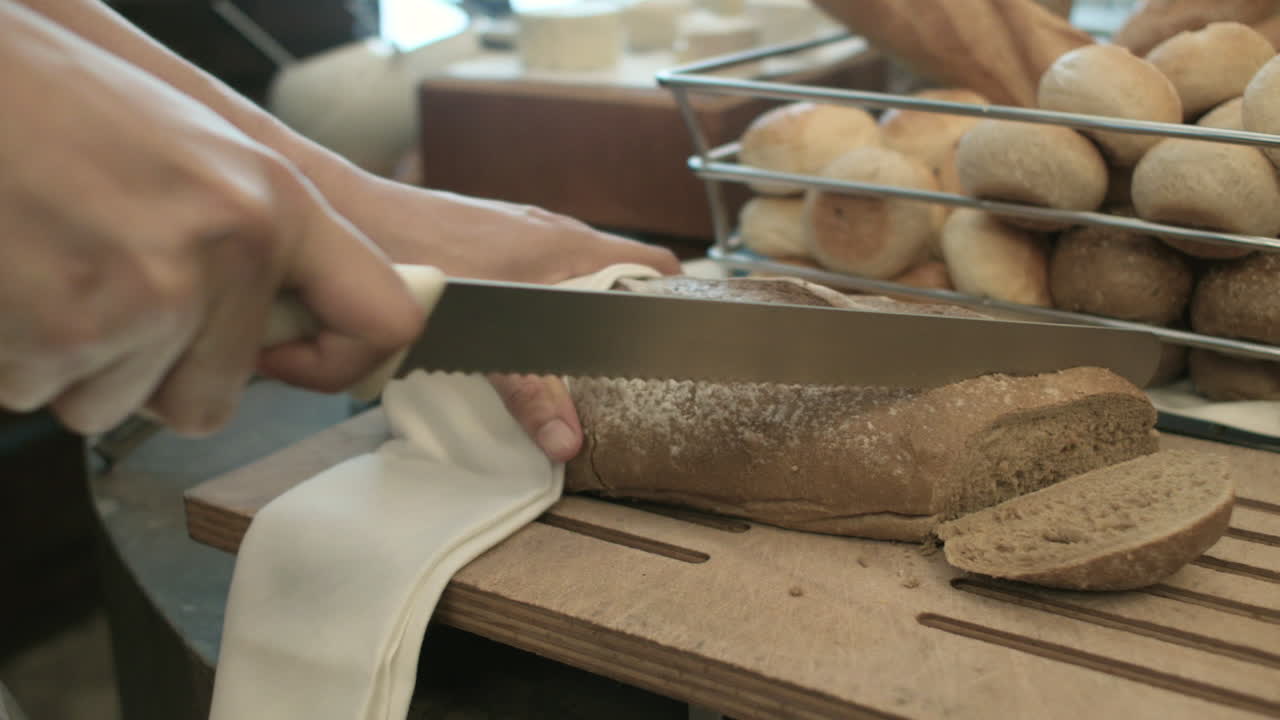 Slicing Loaf Of Bread In A Chopping Board