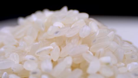 grains of raw rice rotate close-up