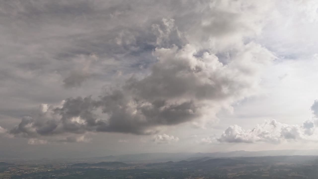 White fluffy clouds float by in a smooth time-lapse capturing peaceful sky movement.