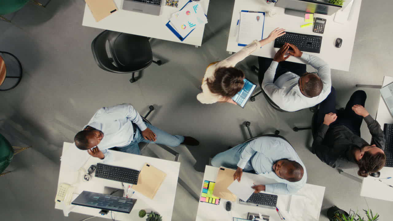 Vertical Video Top down view zoom in of colleagues in multinational company office