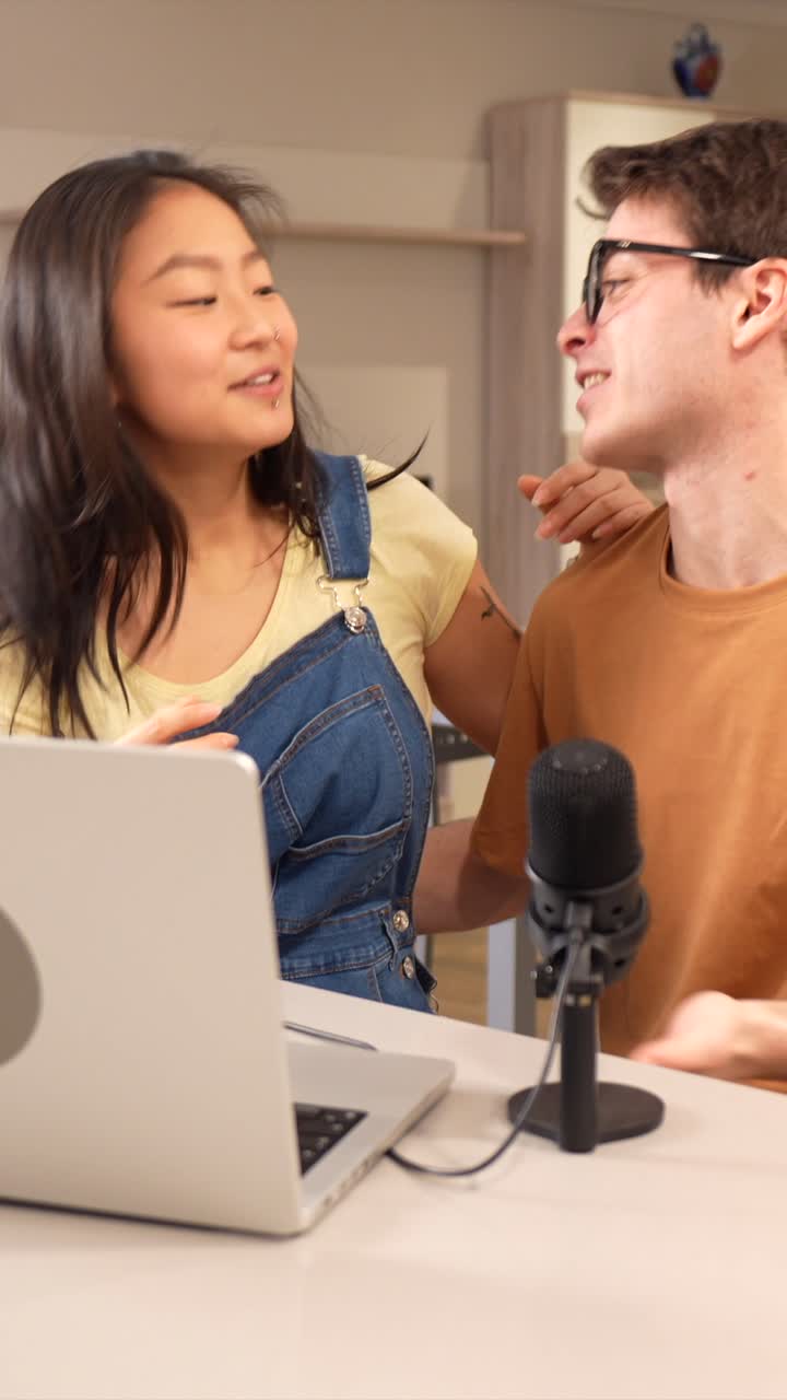 Two people using a laptop