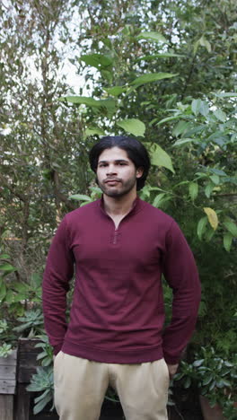 vertical video of portrait of biracial man in nature, slow motion