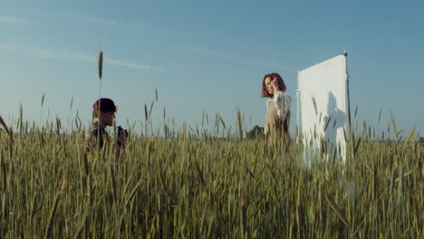 photographer and model in a wheat field