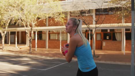 diverse female basketball team playing match, dribbling and shooting ball