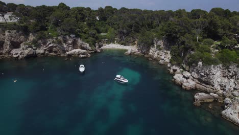 yachts and boats in cote d'azur beach cove on france coastline, aerial