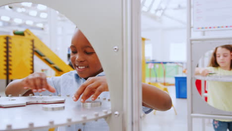 four young kids do practical experiments at a science centre
