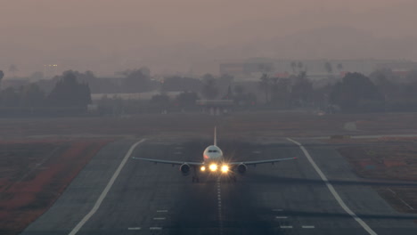 airplane lifting off at twilight