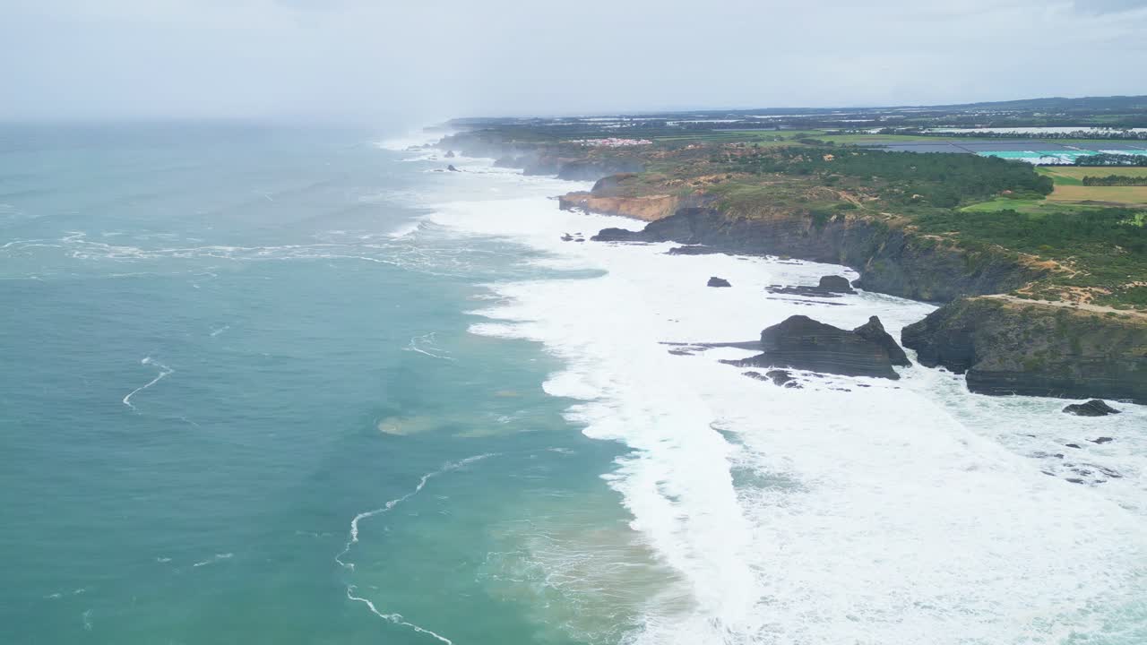 Rocky cliffs meet Atlantic waves on the wild coast of Aljezur, Portugal