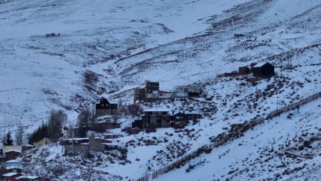 aerial parallax shot of houses built next to the farellones ski resort in the andes