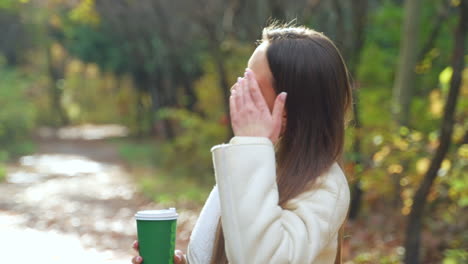 woman enjoying coffee in the park in autumn