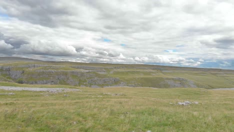 Malham-Cove,-Yorkshire-Dales,-low-level-drone-shot-towards-cliff-edge