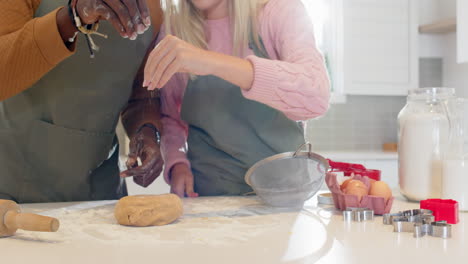 baking christmas cookies together in kitchen, diverse couple preparing dough with joy