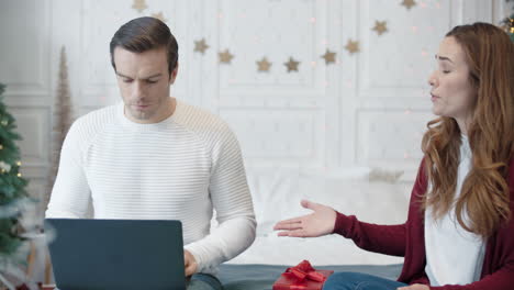 aggressive couple conflicting in modern house on christmas weekend.