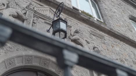 Historic-stone-house-with-old-lamp-above-the-door