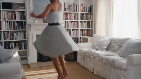 happy dancing woman celebrating with victory dance having fun enjoying success wearing beautiful dress at home 4k