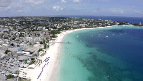 flight above beaches in barbados, bridgetown with deep blue water and calm water