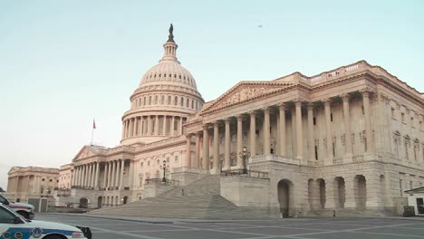 The-Capitol-Building-is-framed-in-soft-light-with-a-police-car-in-foreground